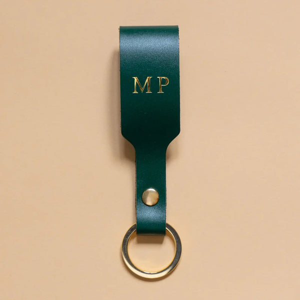 Schlüsselanhänger mit Schlaufe aus tannengrünem Leder und goldenem Ring aus Edelstahl und goldener Prägung