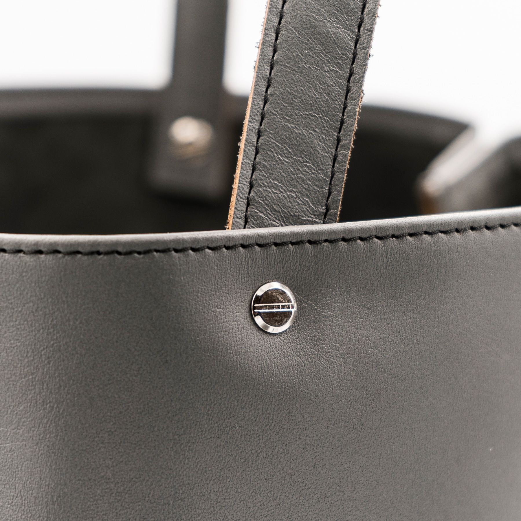 Detailansicht eines grauen Shoppers aus pflanzlich gegerbtem Olivenleder® mit matter Oberfläche und silbernen Schraubnieten